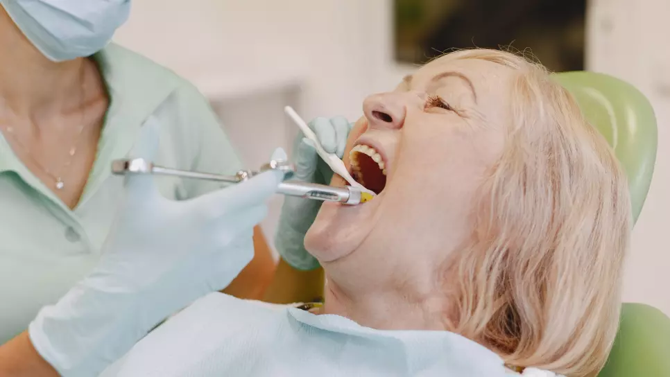Woman getting dentures installed.